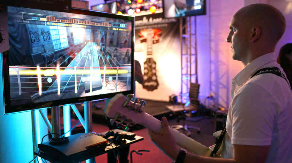 Paul Cross, creative director of Rocksmith, plays the game at a demonstration event in San Francisco, Calif.
