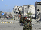In Sirte, fighters loyal to the new government celebrate after the town's defenses finally fell, and former leader Moammar Gadhafi was killed. In Sirte, fighters loyal to the new government celebrate after the town's defenses finally fell, and former leader Moammar Gadhafi was killed.