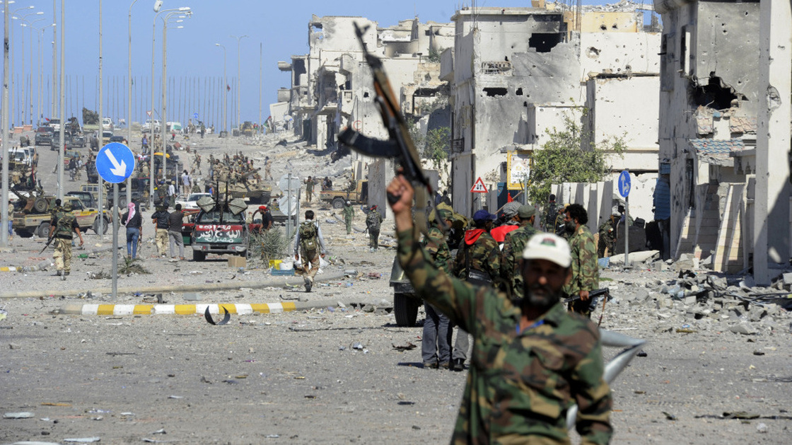 In Sirte, fighters loyal to the new government celebrate after the town's defenses finally fell, and former leader Moammar Gadhafi was killed.