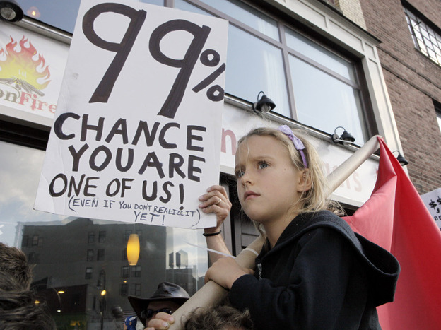 Luoisiana Harris, 7, marches with Occupy Wall Street protesters from their base in Zuccotti Park toward Washington Square last Saturday. Harvard professor Lawrence Lessig says the Occupy Wall Street movement and the Tea Party share some similar concerns.