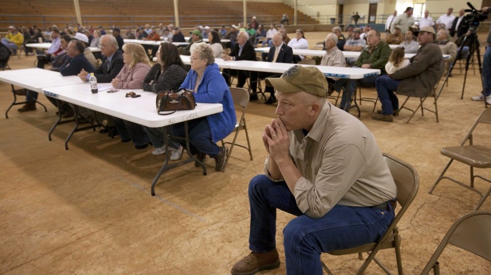 Farmer Scott Allgood, front, of Allgood, Ala., listens during a meeting of farmers and state officials to discuss the impact of the Alabama Immigration law on their livelihoods in Oneonta, Ala.