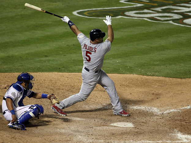 Albert Pujols of the St. Louis Cardinals hits his third home run of the game — tying a World Series single-game record — Saturday night in Arlington, Texas. His team beat the Texas Rangers 16-7 to take a 2-1 lead in the series. 