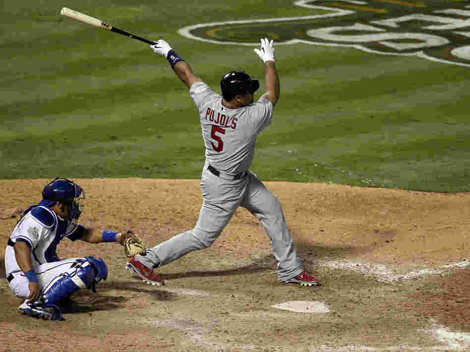 Albert Pujols of the St. Louis Cardinals hits his third home run of the game — tying a World Series single-game record — Saturday night in Arlington, Texas. His team beat the Texas Rangers 16-7 to take a 2-1 lead in the series. 