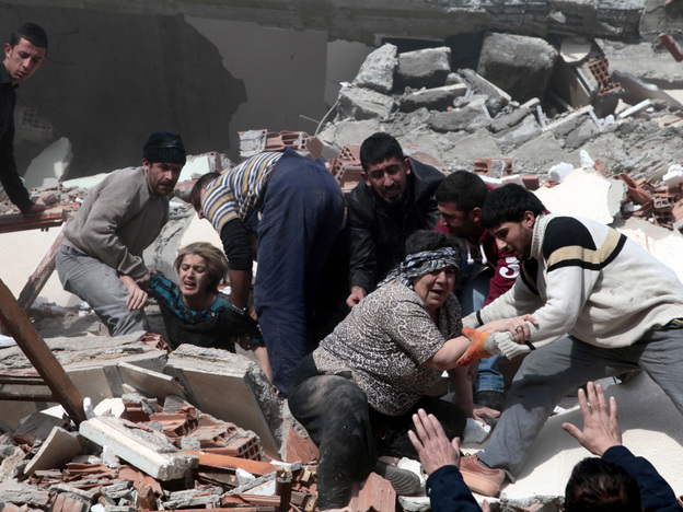 People rescue two women trapped under debris in Van eastsern Turkey after a powerful 7.2-magnitude earthquake struck eastern Turkey, collapsing about 45 buildings in Van province Sunday.