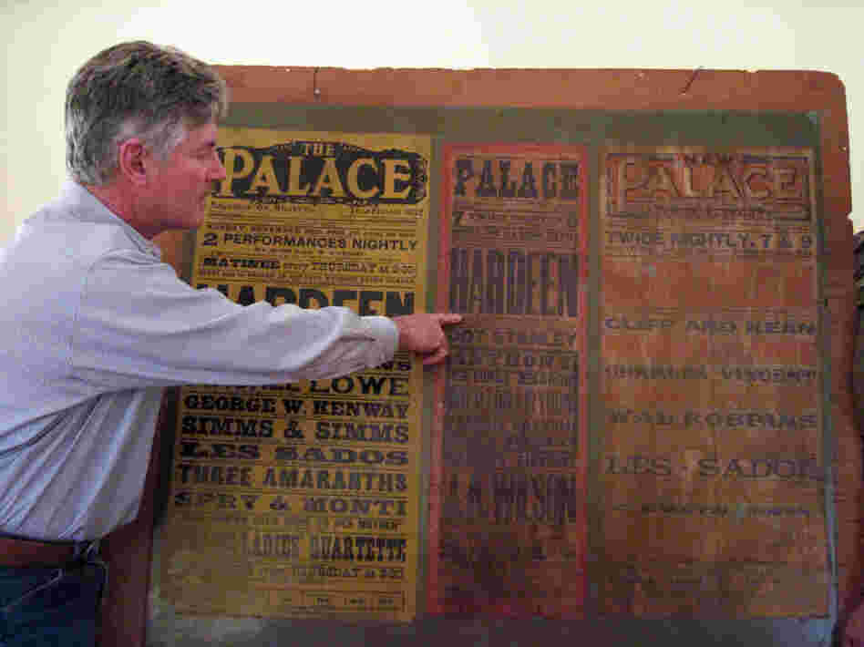 George Hardeen poses with a poster from a 1906 performance by his grandfather, Theo Hardeen. It is the only memento he has of his grandfather. 