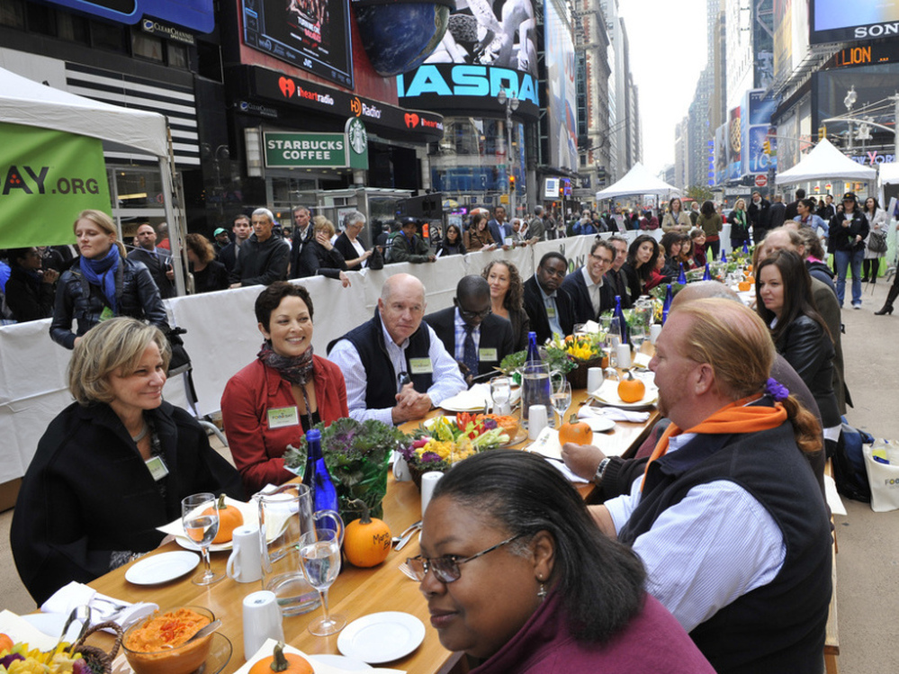 Participants, including Mario Batali, right, at the "Eat In," a Food Day lunch event in Times Square in New York on Monday. 