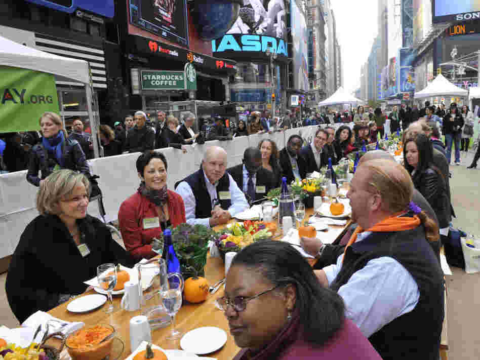 Participants, including Mario Batali, right, at the "Eat In," a Food Day lunch event in Times Square in New York on Monday. 