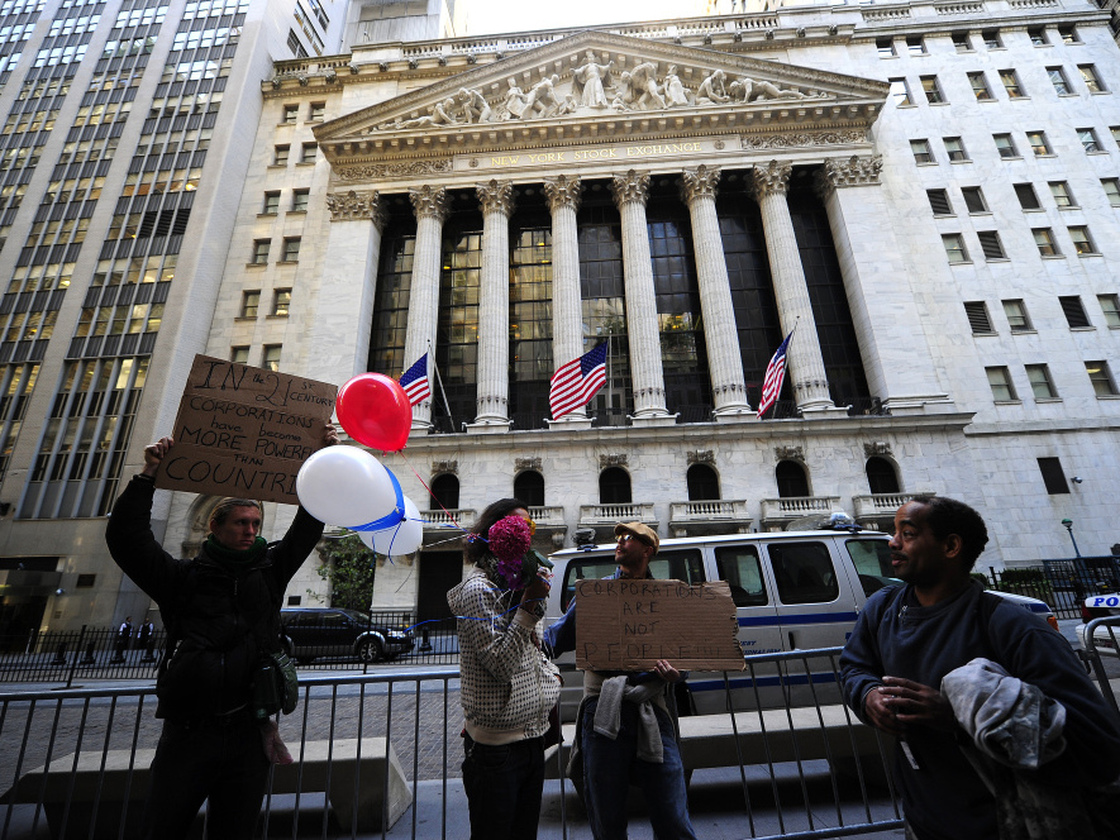 Occupy Wall Street participants demonstrate in front of the New York Stock Exchange in September. The group's press team says the point of the protests is to address the public and not CEOs, whose headquarters have left Wall Street.