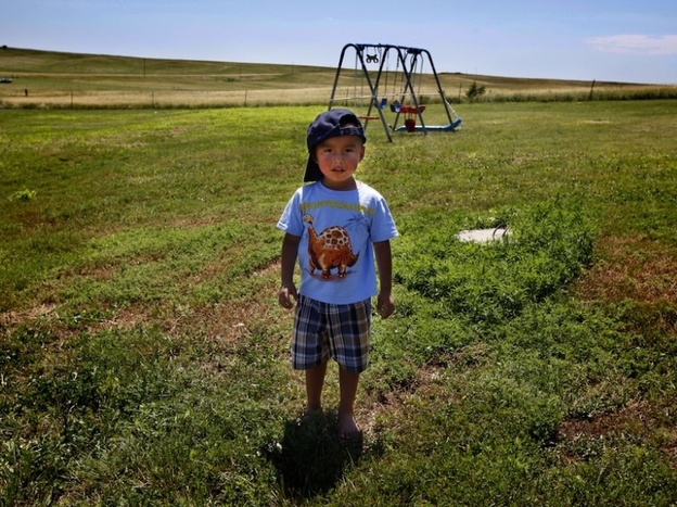 Janice Howe's grandchild Derrin Yellow Robe, 3, stands in his great-grandparents' back yard on the Crow Creek Reservation in South Dakota. Along with his twin sister and two older sisters, he was taken off the reservation by South Dakota's Department of Social Services in July of 2009.