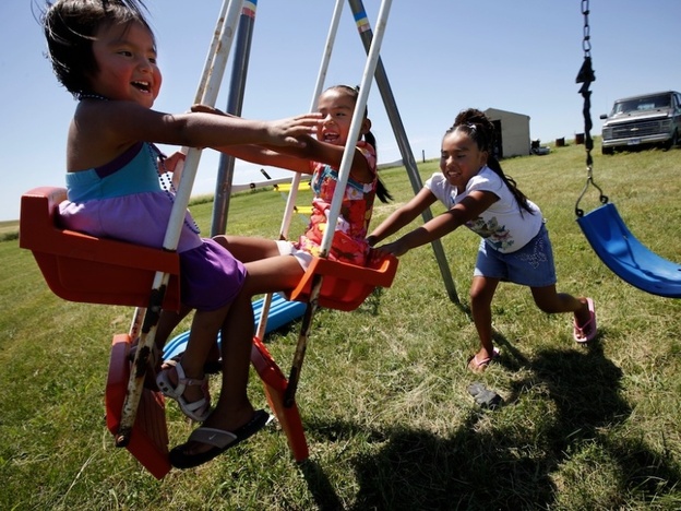 Janice Howe's grandchildren, from left, Daylyn, 3, Rashauna, 6, and Antoinette, 8, play on the Crow Creek Reservation. The children were taken off the reservation by South Dakota's Department of Social Services for a year and a half after a social worker heard an unsubstantiated rumor about their mother's possible abuse of prescription pills. Their mother was never charged with anything.