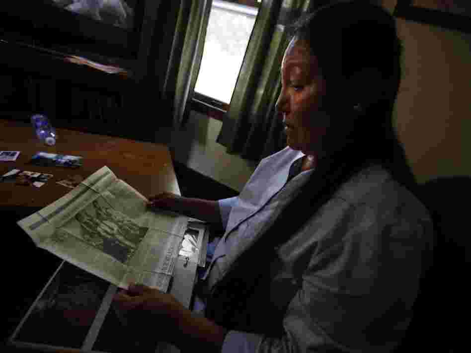 Suzanne Crow looks through a family photo album at her home in Sioux Falls, S.D., and comes across an old newspaper clipping of Sitting Bull, a Hunkpapa Lakota like herself.