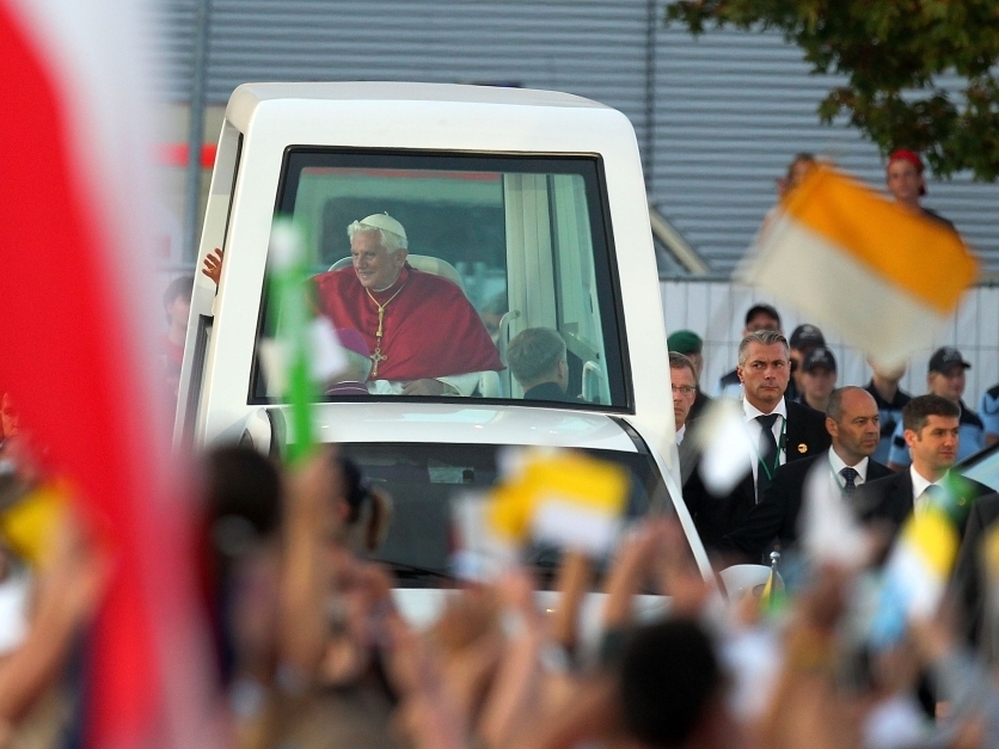Pope Benedict XVI rides in his popemobile through Freiburg im Breisgau, Germany, last month. The Vatican has released a document on world economics, condemning "idolatry of the market."