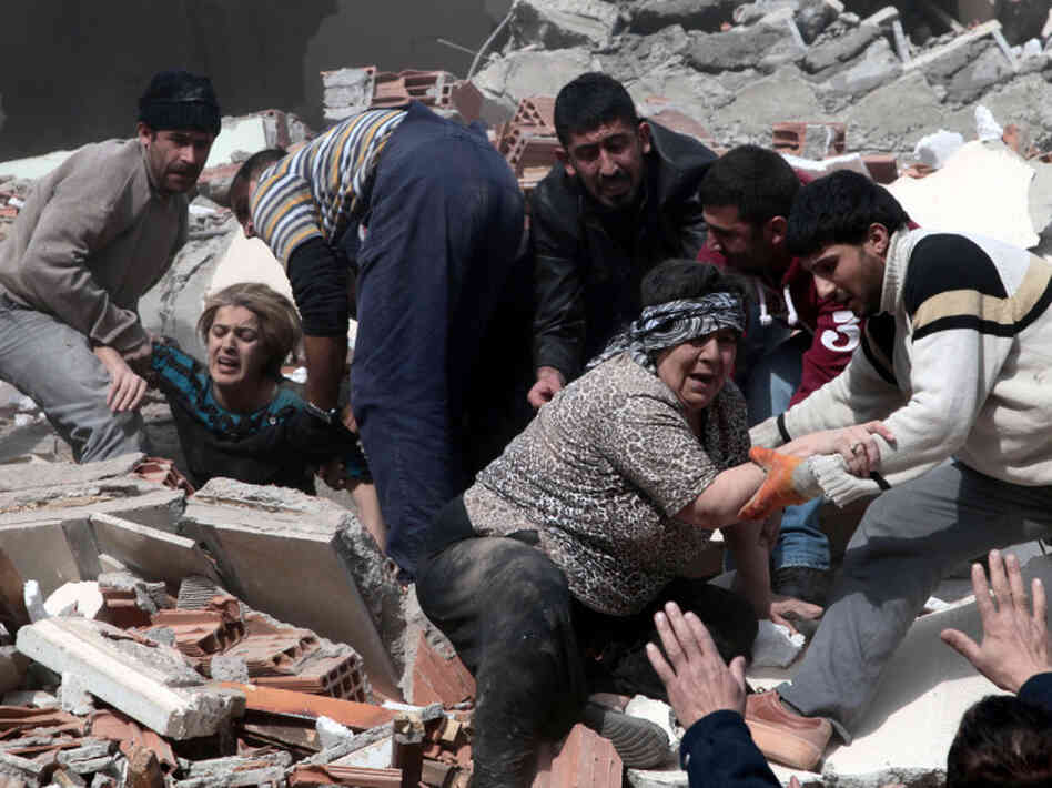 People rescue two women who were trapped under debris after a powerful 7.2-magnitude earthquake in Van, eastern Turkey, on Sunday. People rescue two women who were trapped under debris after a powerful 7.2-magnitude earthquake in Van, eastern Turkey, on Sunday.