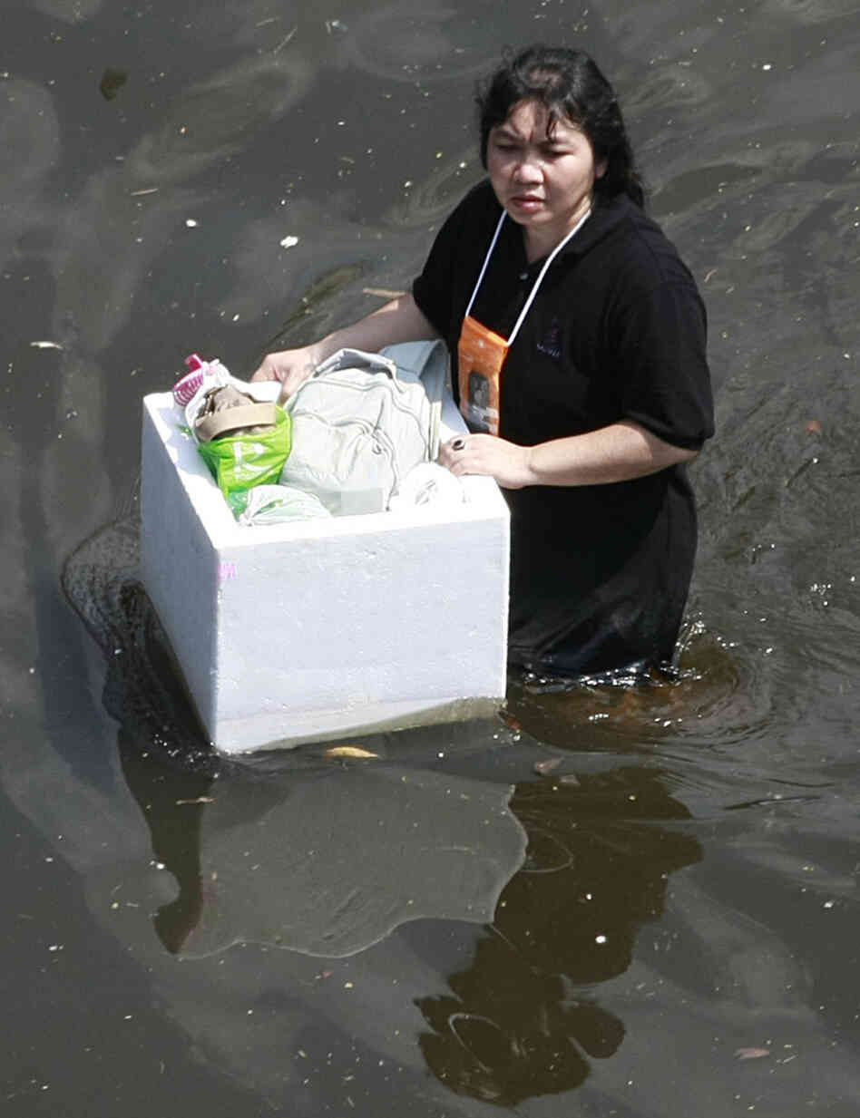 Earlier today (Oct. 24, 2011), a woman floated her belongings as she walked on a flooded road in Bangkok. Earlier today (Oct. 24, 2011), a woman floated her belongings as she walked on a flooded road in Bangkok.