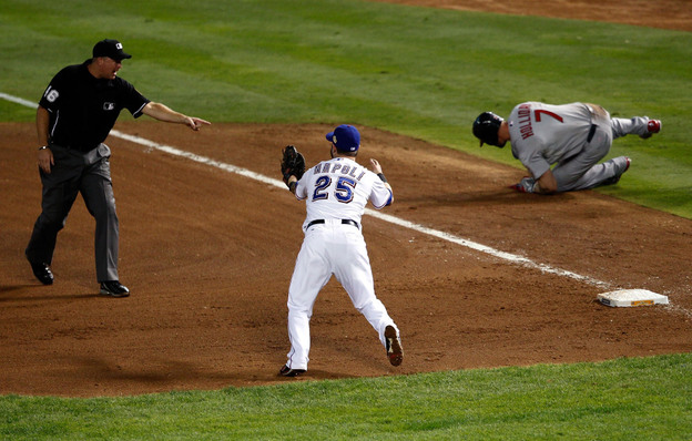 Mike Napoli of the Texas Rangers reacts after first base umpire Ron Kulpa calls Matt Holliday of the St. Louis Cardinals safe in the fourth inning of game three of the World Series.