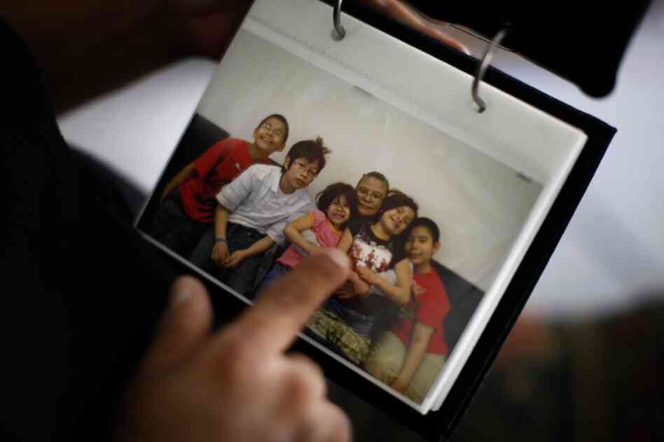 Here, Thunder points to a picture of her grandchildren that was taken during one of her monthly visits. From left are: Jason Martinez, Jr., Ryan Uses the Knife, Janae, Lois Thunder, Angel and Jayden.