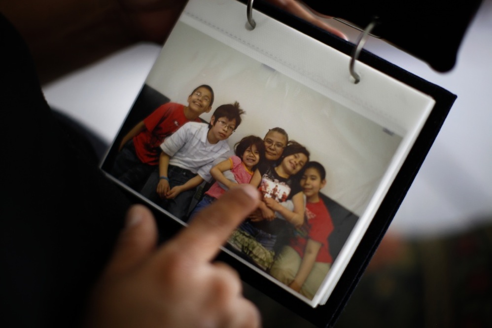 Here, Thunder points to a picture of her grandchildren that was taken during one of her monthly visits. From left are: Jason Martinez, Jr., Ryan Uses the Knife, Janae, Lois Thunder, Angel and Jayden.