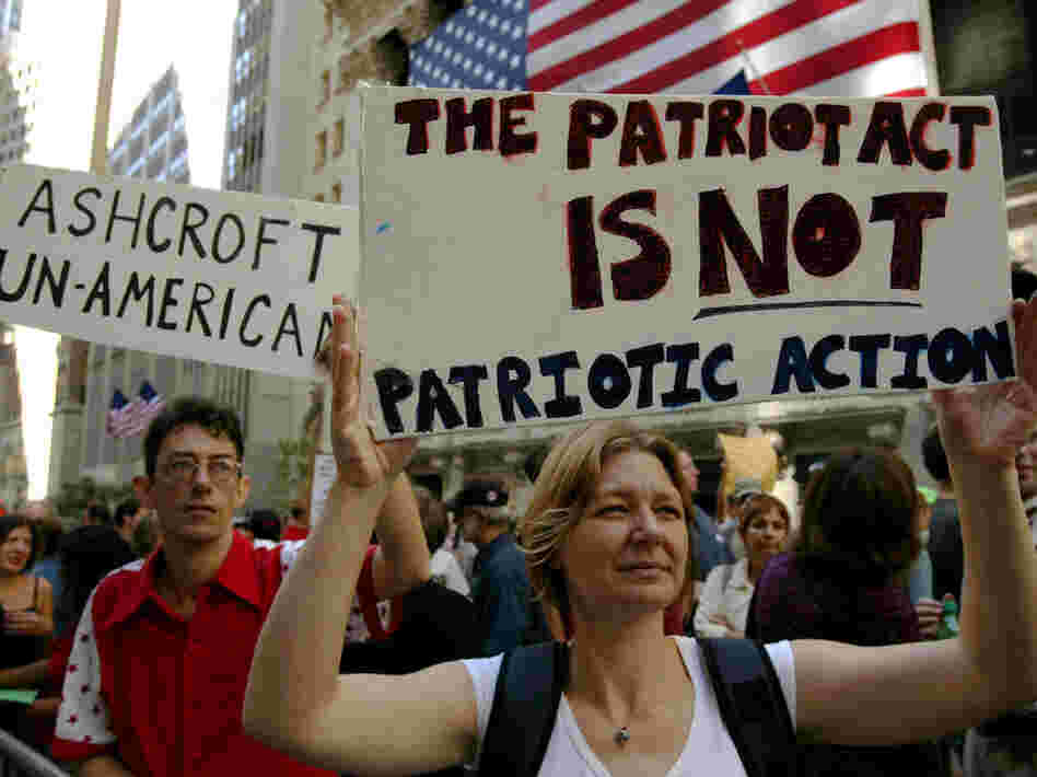 Protesters hold up signs outside of Federal Hall during a demonstration against then-U.S. Attorney General John Ashcroft in 2003 in New York City. Protesters hold up signs outside of Federal Hall during a demonstration against then-U.S. Attorney General John Ashcroft in 2003 in New York City.