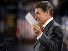 Republican presidential candidate Rick Perry holds up a postcard representing his flat tax plan Tuesday in Gray Court, S.C. Perry toured the factory and then highlighted an optional 20 percent flat tax and a deficit reduction plan. Republican presidential candidate Rick Perry holds up a postcard representing his flat tax plan Tuesday in Gray Court, S.C. Perry toured the factory and then highlighted an optional 20 percent flat tax and a deficit reduction plan.