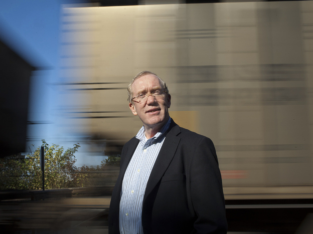 Bellingham Mayor Dan Pike stands in front of a passing coal train at one of the major parks in downtown Bellingham. The proposed coal port is a big issue politically, and Pike is fully opposed to the port development.