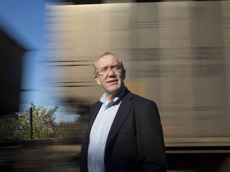 Bellingham Mayor Dan Pike stands in front of a passing coal train at one of the major parks in downtown Bellingham. The proposed coal port is a big issue politically, and Pike is fully opposed to the port development.
