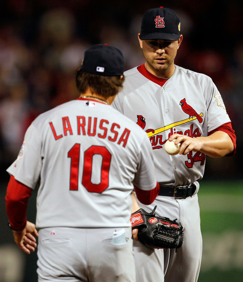 A little too late: Pitcher Marc Rzepczynski of the St. Louis Cardinals is removed by manager Tony La Russa in the eighth inning during Game Five of the MLB World Series against the Texas Rangers. Earlier in the inning, Rzepczynski was mistakenly left in the game because of a miscommunication between LaRussa and his bullpen. And the pitcher gave up the game-winning hit.