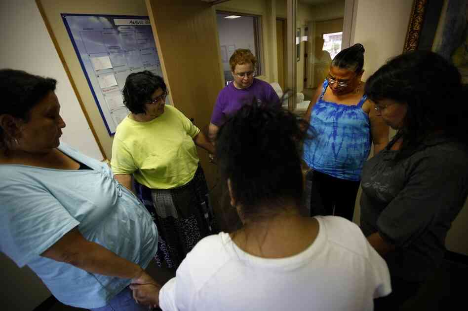 Members of the Sioux Falls 'Grandmother's Group,' join in a group prayer at the end of their weekly meeting.  They meet to commiserate and help support each other as they try to get their grandchildren back from state custody. Clockwise from left are: Delores Highpine, Vernaline Gogue, Linda Herzberg, Lois Thunder, Marilyn Lone Hill and Edie LaRoche-Provencial.