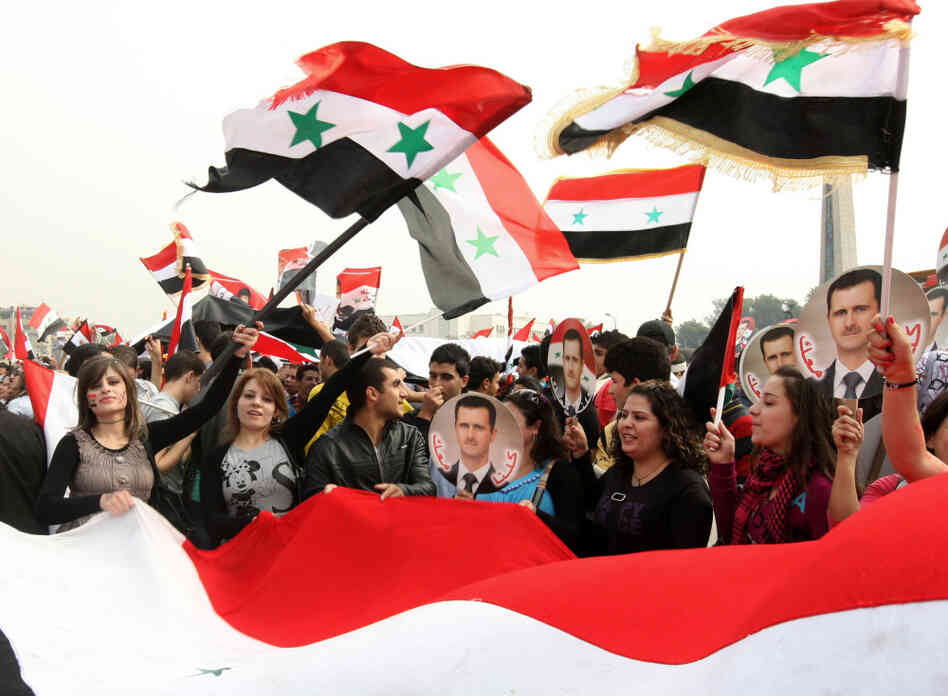 Tens of thousands of people rally in support of Syrian President Bashar al-Assad in Damascus on Wednesday.