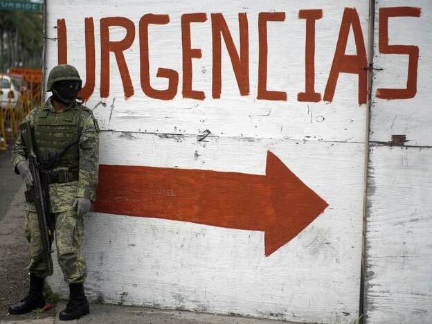 A Mexican soldier takes position near the Regional Hospital of Veracruz earlier this month. The armed forces patrol the streets of the port city in an attempt to combat rising drug violence.