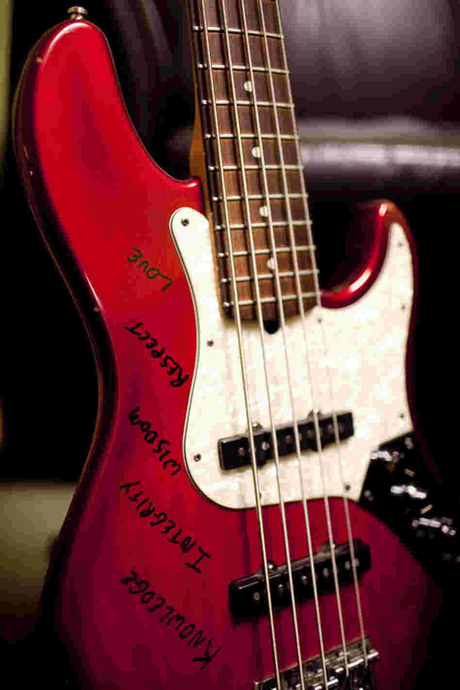 Derrick Hodge's bass reads "Knowledge, Integrity, Wisdom, Respect, Love."