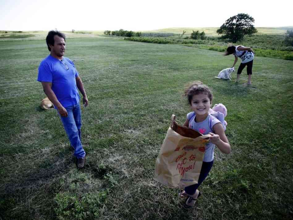 Dwayne Stenstrom and his wife, Rose, live on South Dakota's Rosebud reservation, where they raised six children. Also pictured is their granddaughter.