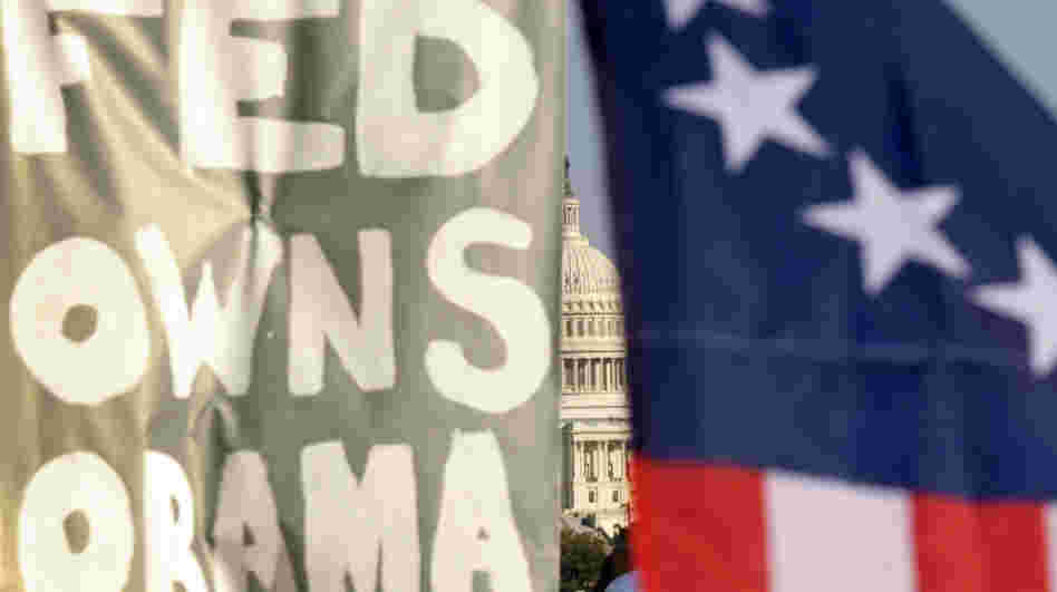 A sign at an Occupy D.C. protest reads "Fed Owns Obama." The president has so far had the worst of both worlds, with much of Wall Street convinced he's anti-business, and the protesters convinced he's in bed with the banks. A sign at an Occupy D.C. protest reads "Fed Owns Obama." The president has so far had the worst of both worlds, with much of Wall Street convinced he's anti-business, and the protesters convinced he's in bed with the banks.
