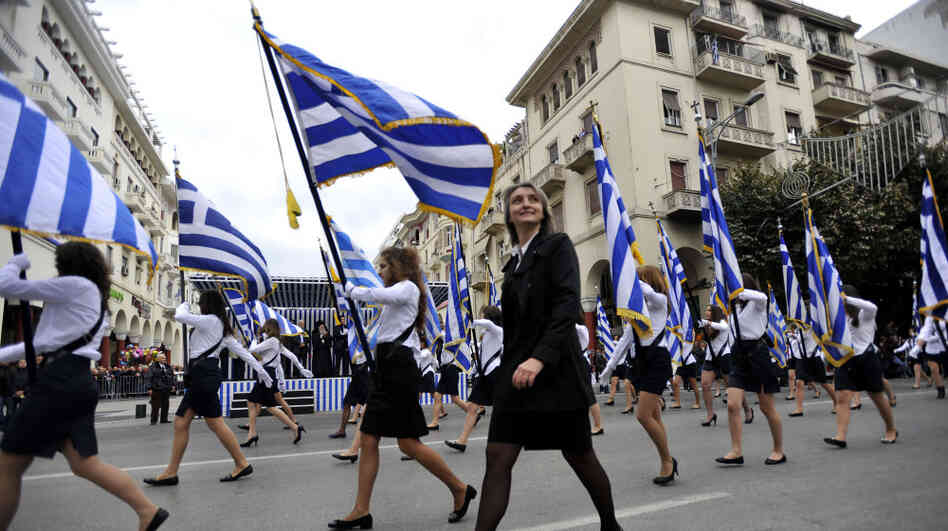 A teacher walks by during a parade in the northern Greek city of Thessaloniki on Thursday. Parades were held across Greece on Thursday to mark the 61st anniversary of the country's resistance to Axis forces, which dragged Greece into World War II. Some bystanders also seized the opportunity to shout anti-austerity slogans. A teacher walks by during a parade in the northern Greek city of Thessaloniki on Thursday. Parades were held across Greece on Thursday to mark the 61st anniversary of the country's resistance to Axis forces, which dragged Greece into World War II. Some bystanders also seized the opportunity to shout anti-austerity slogans.