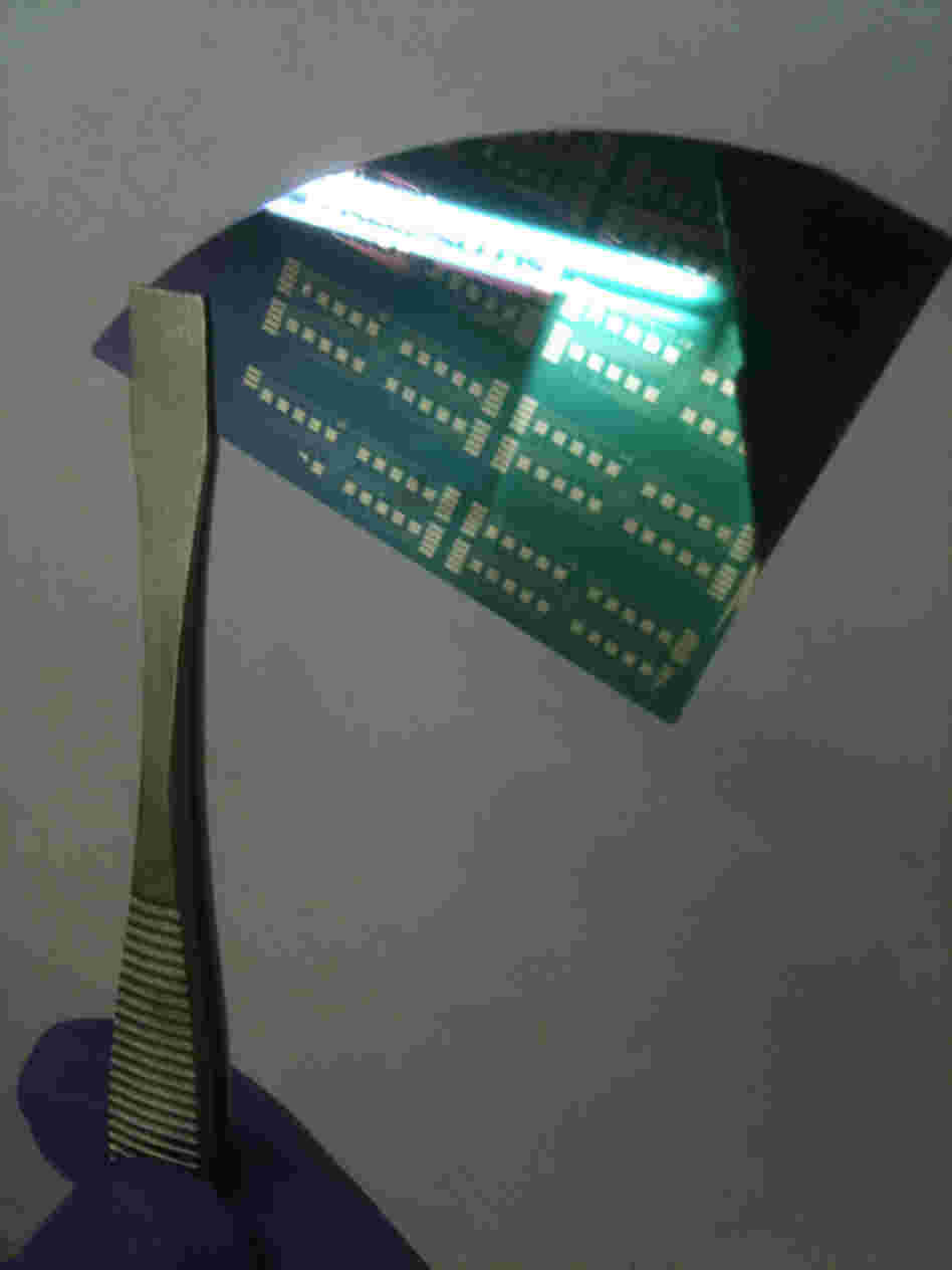 A pair of tweezers holds a graphene transistor fabricated on a silicon wafer. An I-Corps team from the University of Pennsylvania is working on scaling up their cheaper method of making high-quality graphene, an extremely strong, conductive material one atom thick that was the subject of a Nobel Prize last year.
