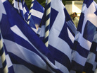 A pedestrian passes a vendor selling Greek flags in Athens on Wednesday (Oct. 26, 2011). Greece's crushing debts triggered the latest crisis. A pedestrian passes a vendor selling Greek flags in Athens on Wednesday (Oct. 26, 2011). Greece's crushing debts triggered the latest crisis.