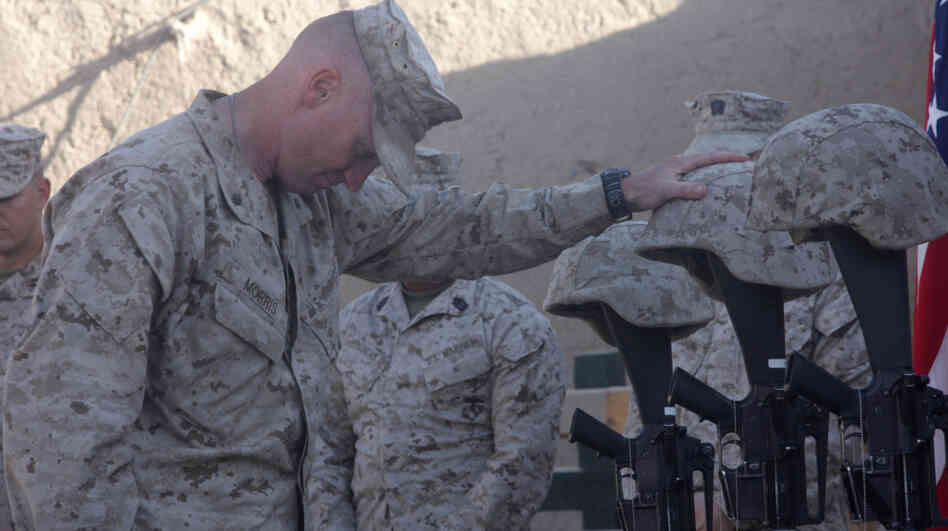 Lt. Col. Jason Morris pays his respects at a memorial service in Sangin, Afghanistan, on Nov. 26, 2010, for three Marines who were killed: Lance Cpl. Brandon Pearson, Lance Cpl. Matthew Broehm and 1st Lt. Robert Kelly. Morris commanded a battalion in volatile Helmand province that suffered the highest casualty rate of any Marine unit in the Afghanistan War.