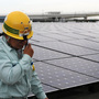 A worker stands next to an array of Sharp solar cell modules at a power plant south of Tokyo in August. Sharp was one of 1,400 solar panel manufacturers in attendance at the Solar Power International conference, where industry optimism was high. A worker stands next to an array of Sharp solar cell modules at a power plant south of Tokyo in August. Sharp was one of 1,400 solar panel manufacturers in attendance at the Solar Power International conference, where industry optimism was high.
