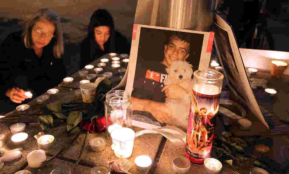 A photograph of Iraq War veteran Scott Olsen is seen Thursday at a vigil. Olsen was severely injured during a standoff between police and protesters in Oakland, Calif., two days earlier. He remains hospitalized. A photograph of Iraq War veteran Scott Olsen is seen Thursday at a vigil. Olsen was severely injured during a standoff between police and protesters in Oakland, Calif., two days earlier. He remains hospitalized.