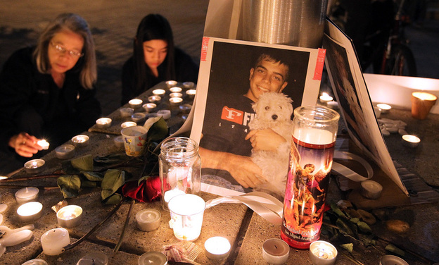 A photograph of Iraq War veteran Scott Olsen is seen Thursday at a vigil. Olsen was severely injured during a standoff between police and protesters in Oakland, Calif., two days earlier. He remains hospitalized. A photograph of Iraq War veteran Scott Olsen is seen Thursday at a vigil. Olsen was severely injured during a standoff between police and protesters in Oakland, Calif., two days earlier. He remains hospitalized.