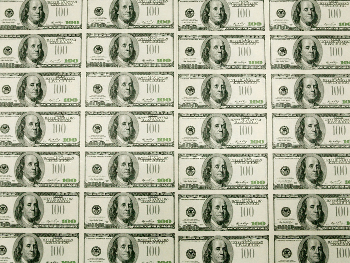 Sheets of $100 bills wait to be cut into singles at the Bureau of Engraving and Printing in Washington, D.C. In recent decades, the gap between rich and poor has widened in the United States.