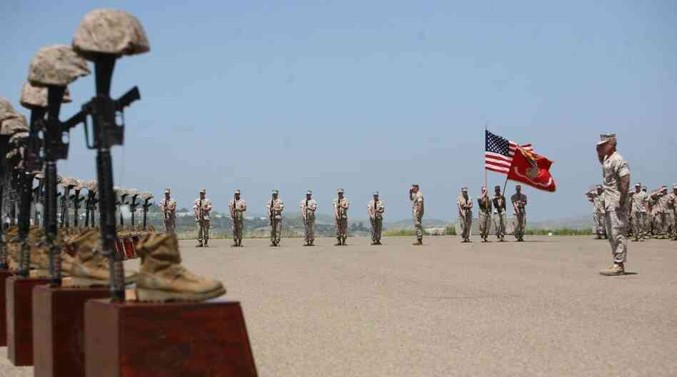 Marines with 3rd Battalion, 5th Regiment salute during the playing of taps at a memorial ceremony on April 29 at Camp Pendleton, Calif. Moments before, the Marines fired a 21-gun salute in honor of the 25 fallen warriors of the battalion.