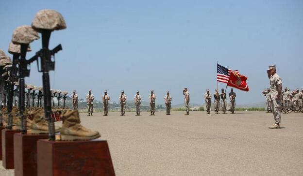 Marines with 3rd Battalion, 5th Regiment salute during the playing of taps at a memorial ceremony on April 29 at Camp Pendleton, Calif. Moments before, the Marines fired a 21-gun salute in honor of the 25 fallen warriors of the battalion.