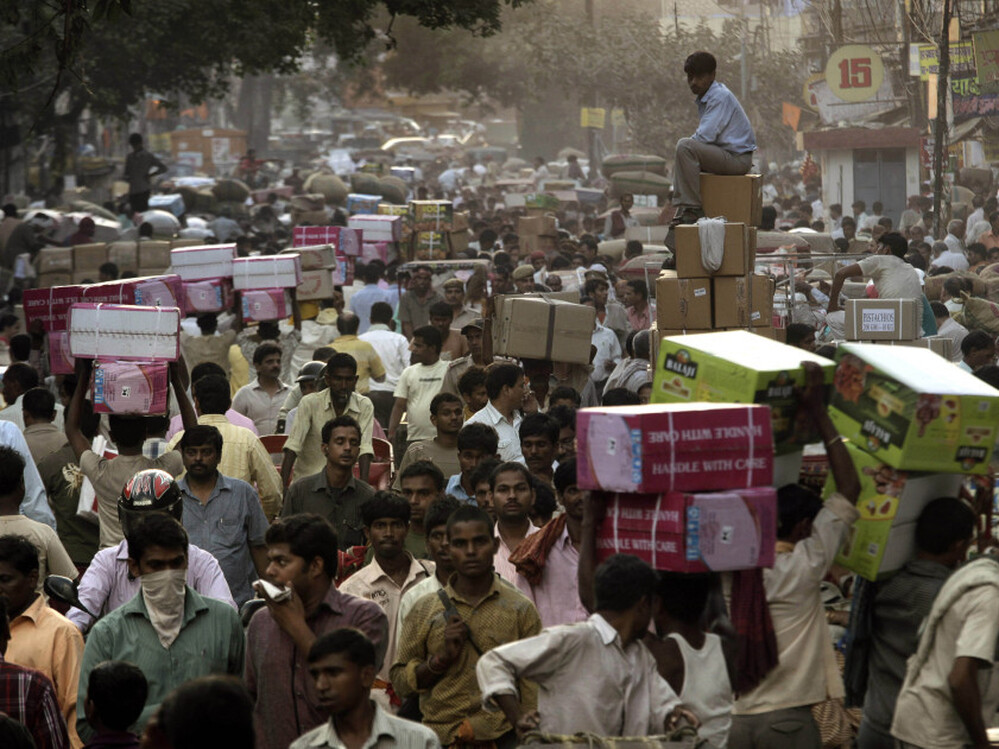 Crowds pack a wholesale market in New Delhi. Already the second most populous country with 1.2 billion people, India is expected to overtake China around 2030.