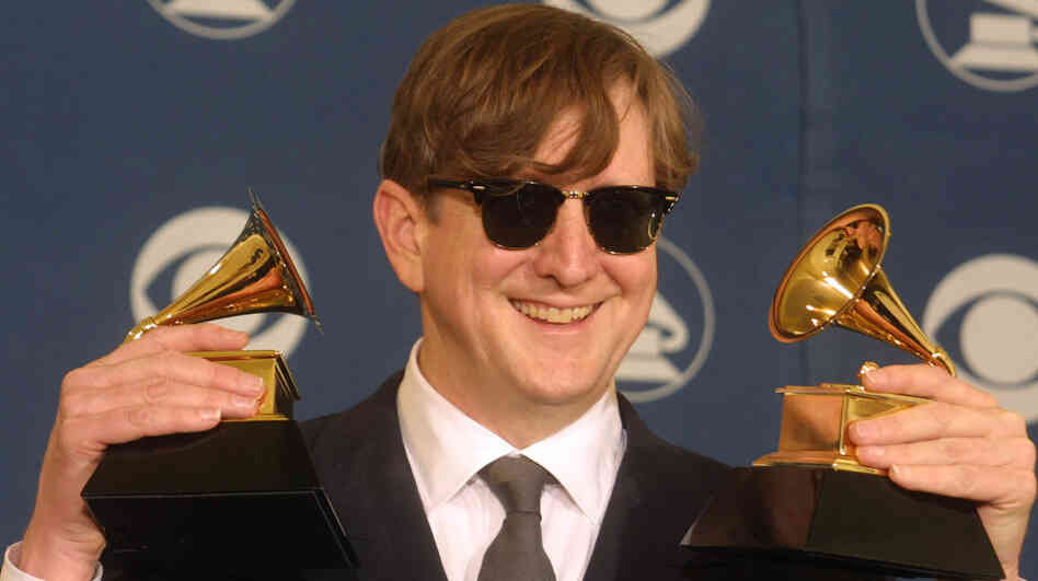 T Bone Burnett holds two trophies, one for Producer of the Year, at the Grammy Awards in 2002.