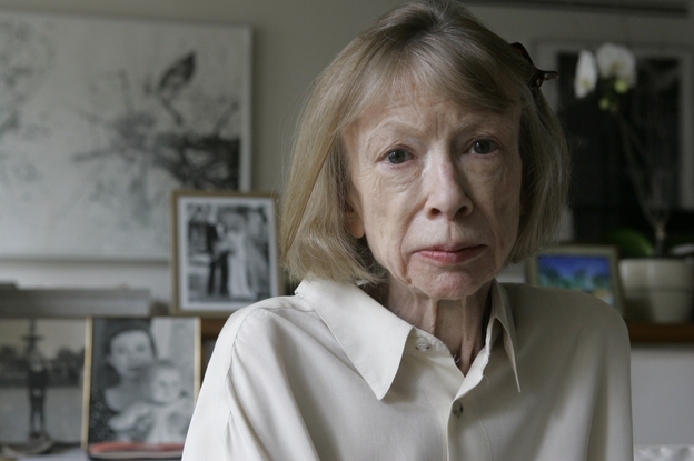 Sitting behind Didion in her New York apartment are photographs of herself holding Quintana Roo, and a photograph from Quintana Roo's 2003 wedding.
