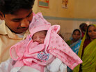 Father of Nargis, a symbolic 7 billionth baby, looks at his daughter at the Community Health Center in Mall, about 28 miles from Lucknow, India's most populous state of Uttar Pradesh, India, Father of Nargis, a symbolic 7 billionth baby, looks at his daughter at the Community Health Center in Mall, about 28 miles from Lucknow, India's most populous state of Uttar Pradesh, India,