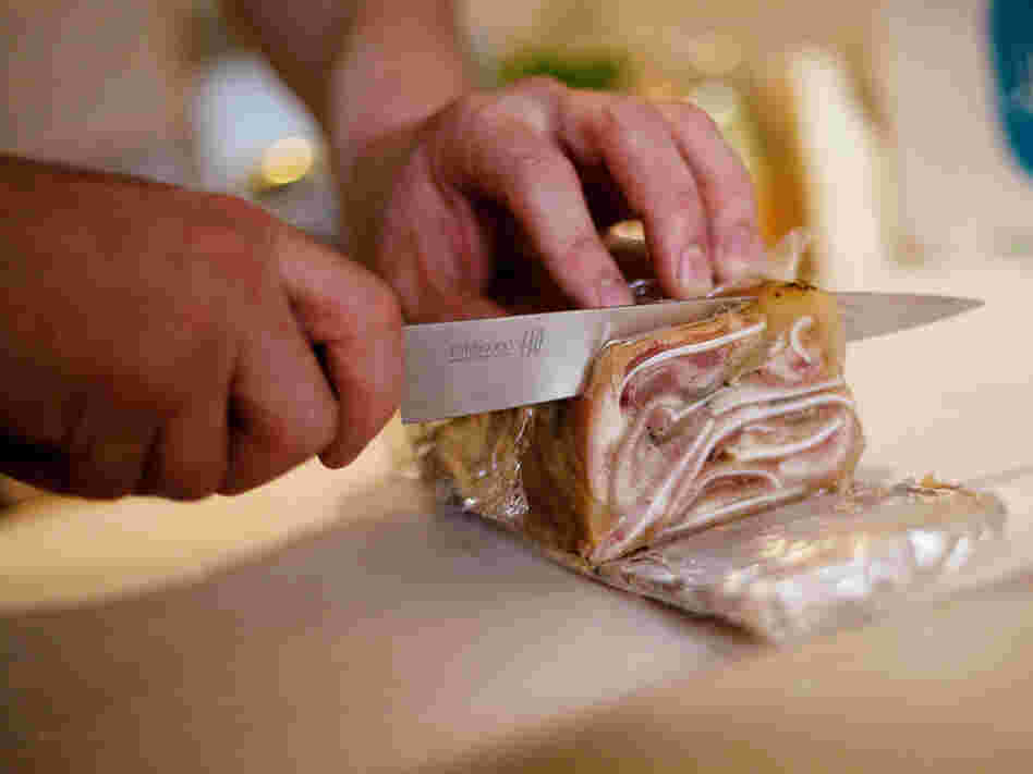 Chef Daniel O'Brien slices the pig ear terrine he made for the "Scary Bits" dinner at his Season Pantry supper club in Washington, D.C.