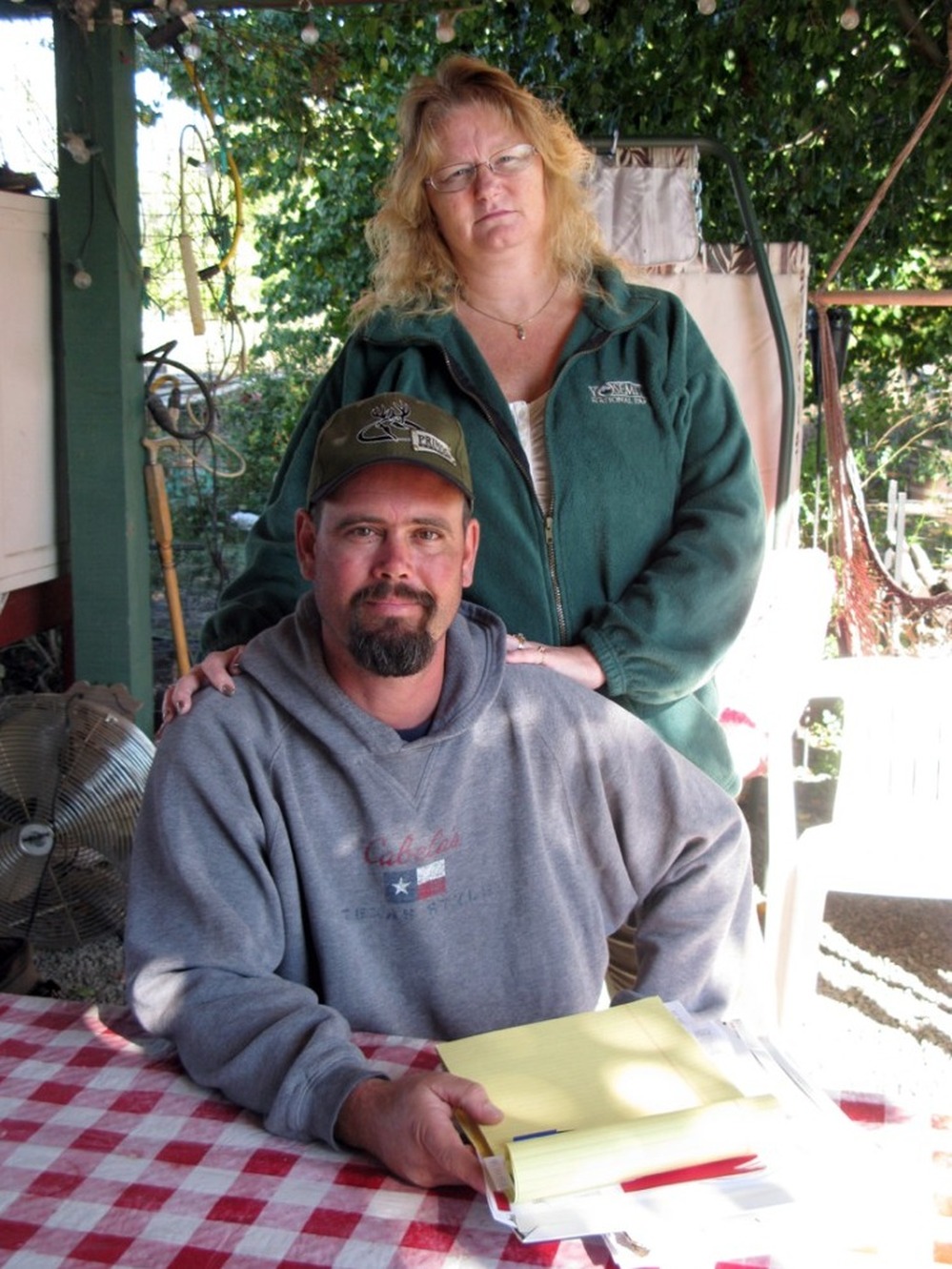 Craig and Linda Black sit at a table in the yard of their home in Vacaville, Calif. They are desperately trying to hang on to their home after falling behind on their mortgage payments.