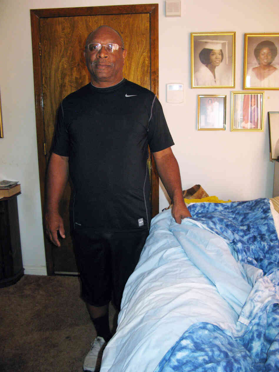  Robert Frazier of Suisun City, Calif., is seen at home with a prototype of "The Pouch," a sleeping bag attached to a fitted sheet, so that both fit over a mattress. He has a patent, but he doesn't want to take production to China or India.