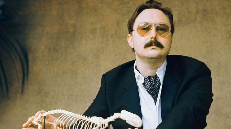 "I could be wrong, you know:" John Hodgman notes that while his book That Is All is intensely concerned with "the coming global superpocalypse," it also contains much information about travel and sports and wine, and is "not depressing." 